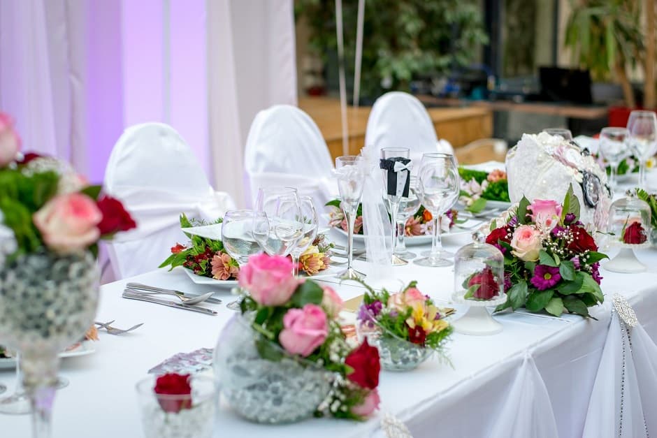 Wedding reception table set with florals and glassware